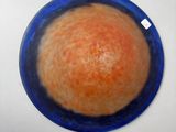 painting of an orange in a blue bowl on a white surface