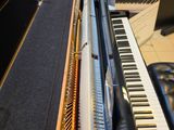 a piano that is sitting next to a piano keyboard