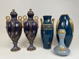 three vases and a vase on a table with a white background
