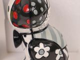 a black and white cat figurine sitting on a shelf