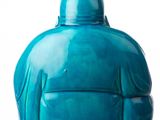 a blue vase that is sitting on a white surface