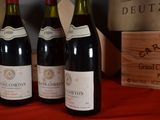 several bottles of wine sitting on a table next to a wooden box