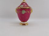 an image of a pink and gold vase on a white surface