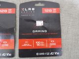 pair of black and red gaming card holders on a gray cloth