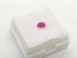 a pink heart shaped stone sitting on top of a white box