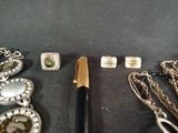 many different types of jewelry on display on a table