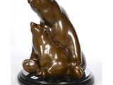 sculpture of a mother bear and her two cubs sitting on a black base
