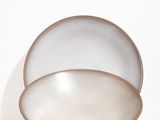 a close up of a white plate with a brown rim
