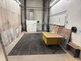 a picture of a room with a bench and a door