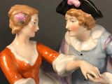 a figurine of a man and a woman holding hands