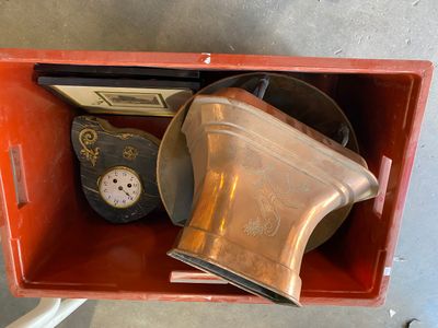 a red box with a clock and other items in it