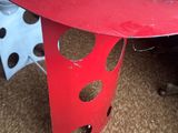 a red table with holes cut out of it