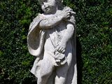 a statue of a boy holding a baby in his arms