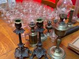 a lot of glass and metal candles on the table