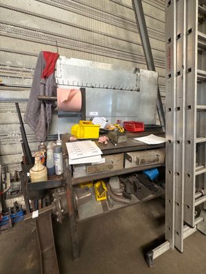 a metal workbench with tools on it in a garage