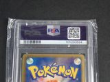 the pokemon card is in a clear plastic holder on a table