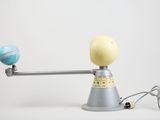 an image of a globe being weighed on a scale