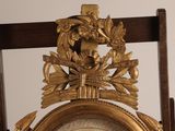 a gold clock with a bird on top of it