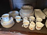a lot of plates and cups on the table