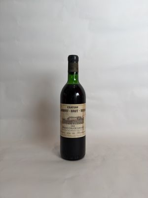 a bottle of wine sitting on top of a white table
