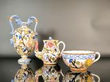trois vases et une tasse posés sur une table