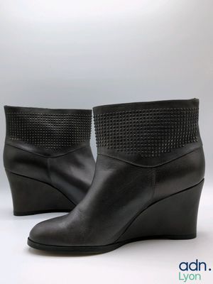 a close up of a pair of black boots on a white background