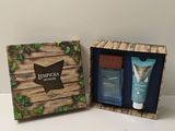 an image of a box with a bottle of perfume and a tube of lotion