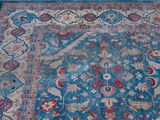 an image of a blue and red oriental rug on the ground