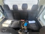 a seat in the back of a van with a bunch of items on it