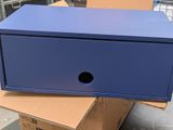 a blue box that is sitting on top of a cardboard box