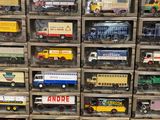 many different types of toy trucks in a display case