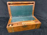 a wooden box with a green lid on a black background