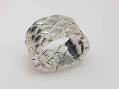 a close up of a ring on a table with a white background