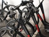 many bikes parked next to each other in a parking lot