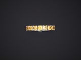 a gold ring with square cut diamonds on a black background
