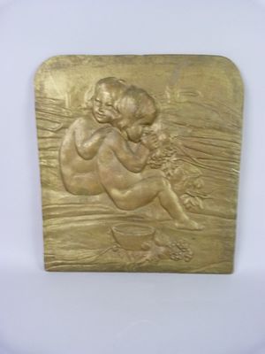 a close up of a gold plaque with a child on it