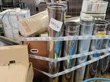 a lot of different types of metal pipes in a warehouse