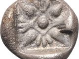 a close up of a coin with a face on it