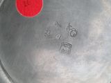 a close up of a metal plate with a red dot on it