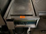 a large stainless steel pan sitting on top of a stove