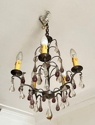 a chandelier that is hanging from the ceiling in the room