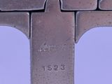 a close up of a metal object with a clock on it