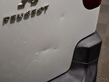 a close up of the rear end of a white car