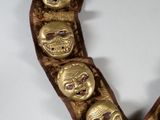 a picture of a gold bracelet with skulls on it