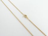 a pair of gold chain necklaces on a white surface