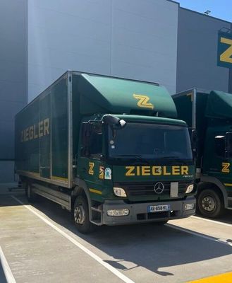 two trucks that are parked in front of a building