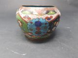 a vase with a colorful design on it on a table