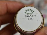 a person holding a small white and gold plate