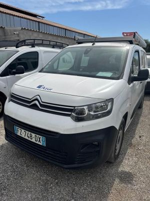 a white van parked in a parking lot next to other cars