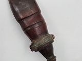 a close up of a knife with a wooden handle on a white surface